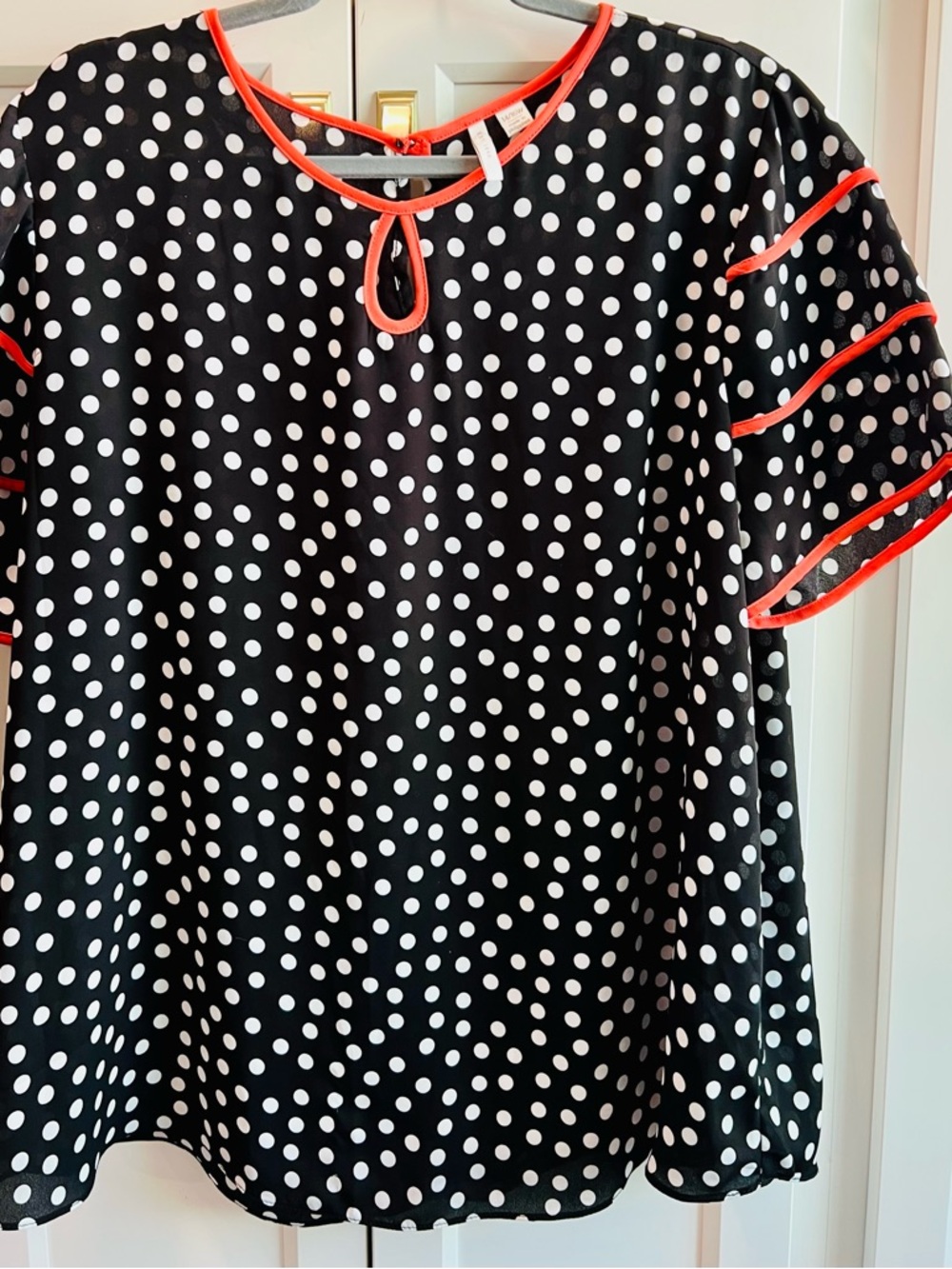 Black & White Polka Dot Blouse with Coral Trim.  Size 14/16 with bell sleeves.
